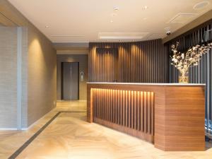 a lobby of a hotel with a reception desk at Hotel Shiki Utsubo Park in Osaka