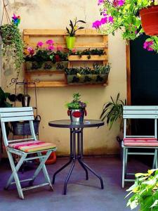 a table and two chairs with flowers on a patio at Apartment Papalić Palace in Split