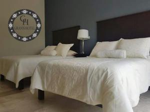 Ένα ή περισσότερα κρεβάτια σε δωμάτιο στο Grann Hotel