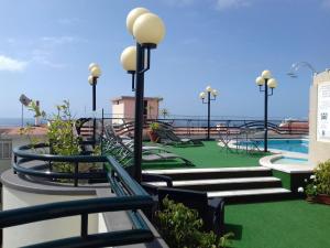 un complejo con piscina y parque infantil con bancos en Hotel Windsor, en Funchal