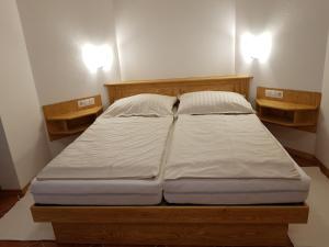 a large bed in a room with two shelves at Pr Bevc in Bled