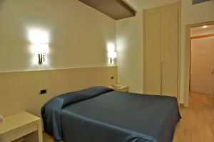 Postelja oz. postelje v sobi nastanitve Sam Hotel