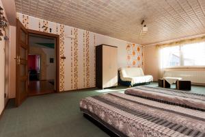 a hotel room with two beds and a bedroom at Waldi in Grzybowo