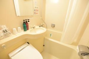 a small bathroom with a sink and a toilet at APA Hotel Isehara-Ekimae in Isehara