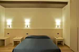 Postelja oz. postelje v sobi nastanitve Sam Hotel