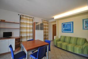 a living room with a table and a couch at Villa Fiorella in Castiglioncello