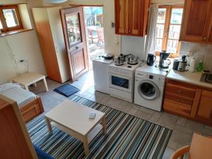 a kitchen with a stove and a washing machine at Amanitis Stone House in Kipoi