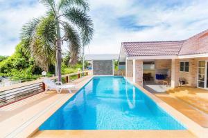 a swimming pool in a house with a villa at Baan Khao Noi Pool Villa in Hua Hin