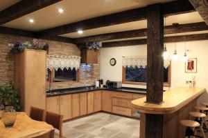 a large kitchen with wooden cabinets and a table at DreamWoods in Puerto Varas