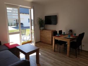 a living room with a table and a couch at Apartamenty Bursztynowe in Dębki