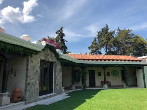 an exterior view of a house with a yard at Casa Faustina Boutique Hotel in Antigua Guatemala