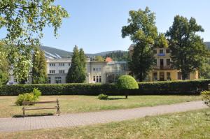 a park bench in front of a building at FWP Rybniczanka - Wanda in Lądek-Zdrój
