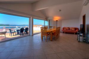 a living room with a table and chairs and a couch at Villa D&I in Srima