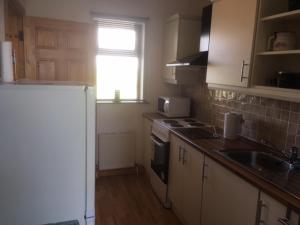 a kitchen with a sink and a stove top oven at Baurleigh studio apartment P72F340 in Lissaphooca Cross Roads