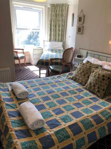 a hotel room with two beds and a window at Chad Hill Hotel in Sandown