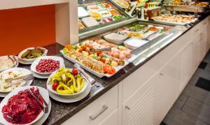 ein Buffet mit vielen verschiedenen Speisen in der Unterkunft Royal Park Boutique Hotel in Budapest