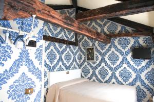 a bedroom with blue and white wallpaper at Hotel Bridge in Venice