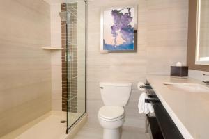 a bathroom with a toilet and a glass shower at Harrah's Laughlin Beach Resort & Casino in Laughlin