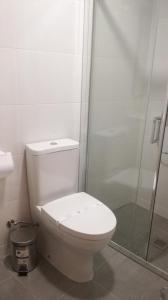 a bathroom with a toilet and a glass shower at Beira Rio do Gerês in Geres
