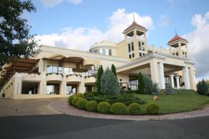 a large white building with a clock tower on it at Duni Belleville - All Inclusive in Sozopol