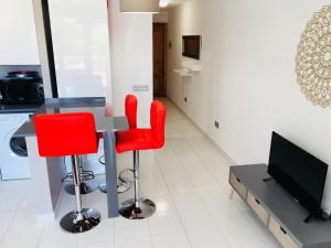 TV a/nebo společenská místnost v ubytování Apartamentos Las Haciendas Altamar