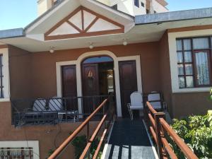 a home with a porch with chairs on it at Apartamento Golden in Cochabamba