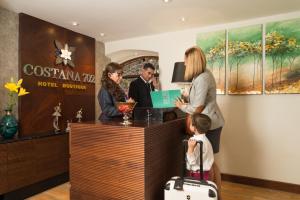 a group of people standing at a hotel counter at Costana 702 Hotel Boutique in Arequipa
