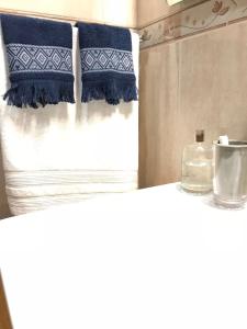 a bedroom with a bed with blue and white pillows at Atico San Crispin in Cartagena +53 photos