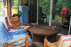 een patio met een tafel en stoelen en een fornuis bij Les Hébergements Nature et Bien-être in Soustons