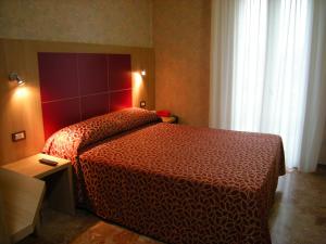 Postel nebo postele na pokoji v ubytování Hotel San Carlo