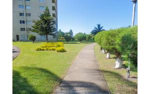 a walking path in a park next to a building at Coconut Shell At Turtle Towers in Ocho Rios