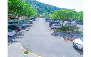 a bunch of cars parked in a parking lot at Coconut Shell At Turtle Towers in Ocho Rios