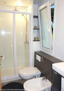 a bathroom with a toilet and a sink and a shower at Camping Home Adriamar in Novigrad Istria