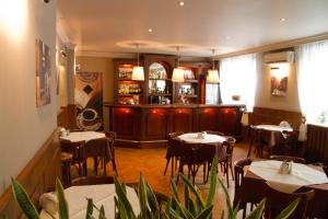a restaurant with tables and chairs and a bar at Hotel Iskra in Rzeszów
