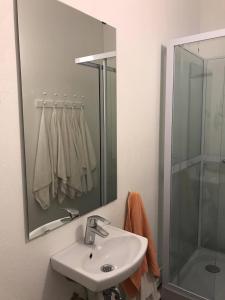 a bathroom with a sink and a shower at Downtown Selfoss - perfectly located apartment in Selfoss