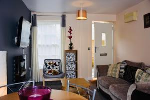 a living room with a couch and a table at 8 York Mews in Shepton Mallet