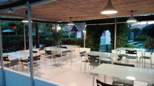 a restaurant with tables and chairs on a patio at Camping Smeraldo in Trevignano Romano