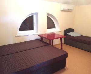 a room with two beds and a table and two windows at House in Karolino-Buhaz in Zatoka +20 photos