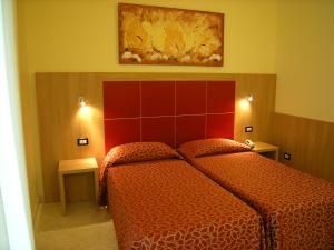 Postel nebo postele na pokoji v ubytování Hotel San Carlo