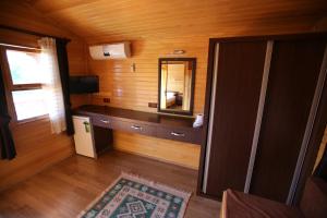 a room with a vanity and a mirror in a room at Ugur Pansiyon Bungalows in Cıralı
