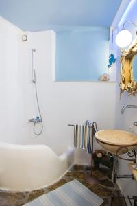 a bathroom with a tub and a sink at The Architect's Village House in Mirsíni