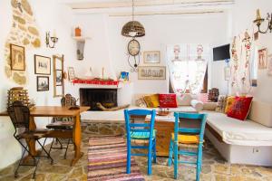 a living room with a table and chairs and a couch at The Architect's Village House in Mirsíni