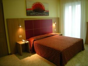 Postel nebo postele na pokoji v ubytování Hotel San Carlo
