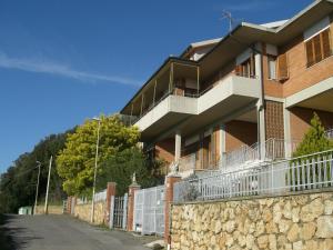 a brick building with a stone wall next to a street at CASA ALLE COSTE camere con vista in Massa Marittima
