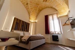 - une chambre avec un lit et une fenêtre dans l'établissement Signuria Dimora Esclusiva, à Lecce