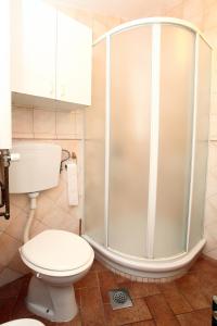 a bathroom with a toilet and a shower at Apartment Svobode Izola in Izola