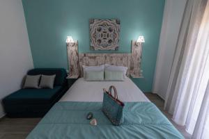a bedroom with a large bed and a couch at Blue Bay Hotel in Skala Potamias