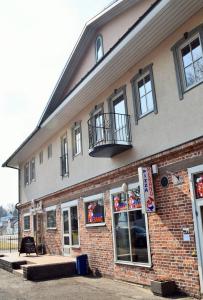 a brick building with a balcony on top of it at Otepää Apartments in Otepää