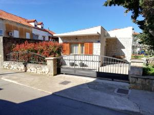 a house with a white fence in front of it at Kod Male Gospe in Tribunj