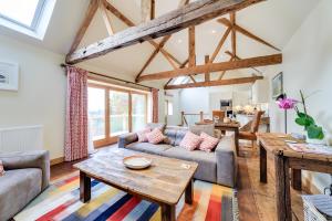 a living room with a couch and a table at The Stables and Hayloft in Ledbury